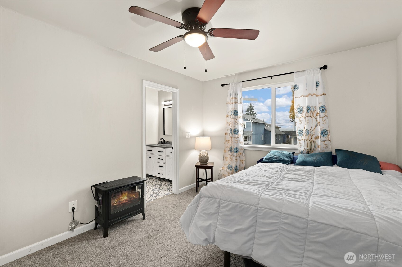 3626 East Howe Street Tacoma, WA 98404 - Photo 17 of 28 a bedroom with a bed and a chandelier