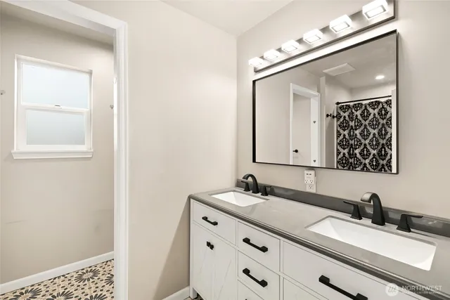a bathroom with a double vanity sink and a mirror