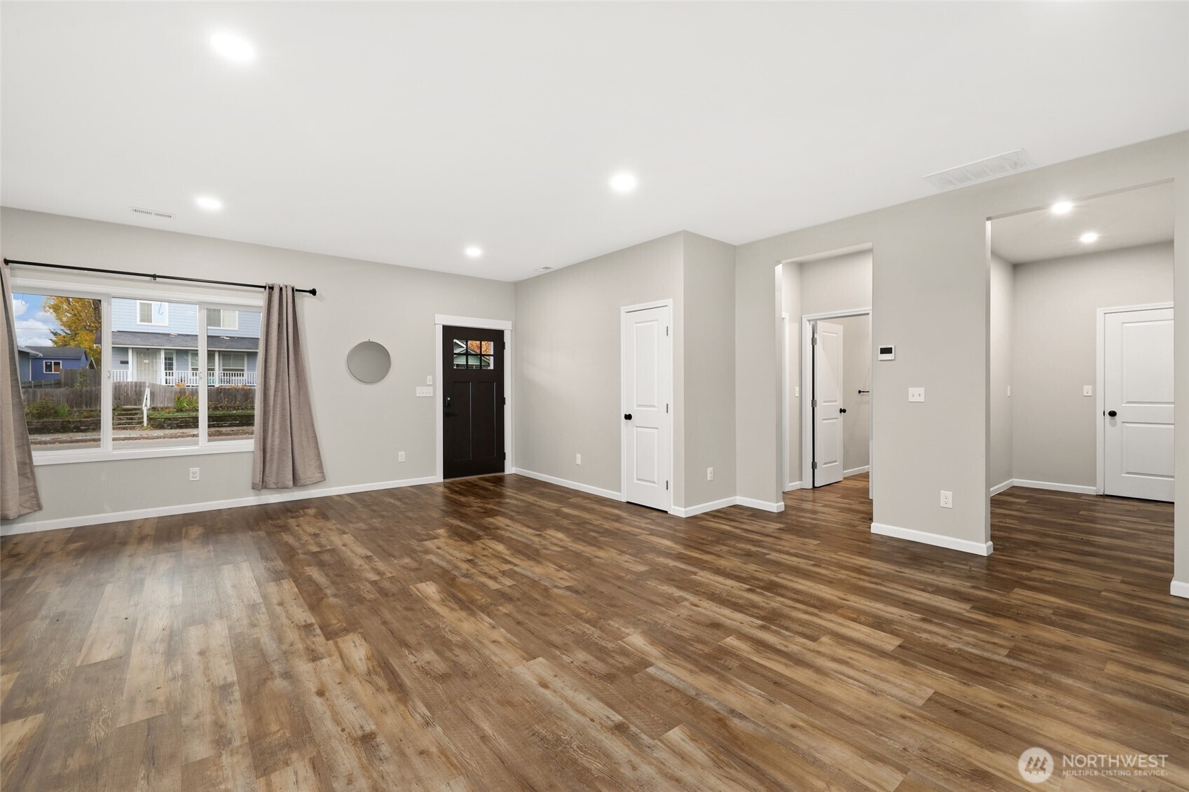 3626 East Howe Street Tacoma, WA 98404 - Photo 2 of 28 a view of an empty room with wooden floor and a window