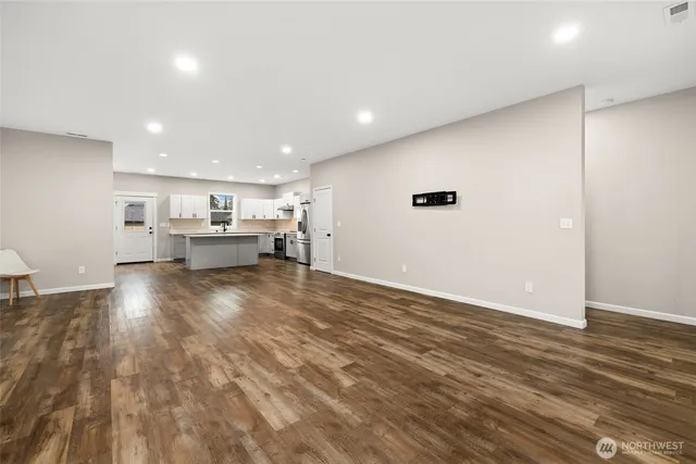 a view of kitchen and hall with wooden floor