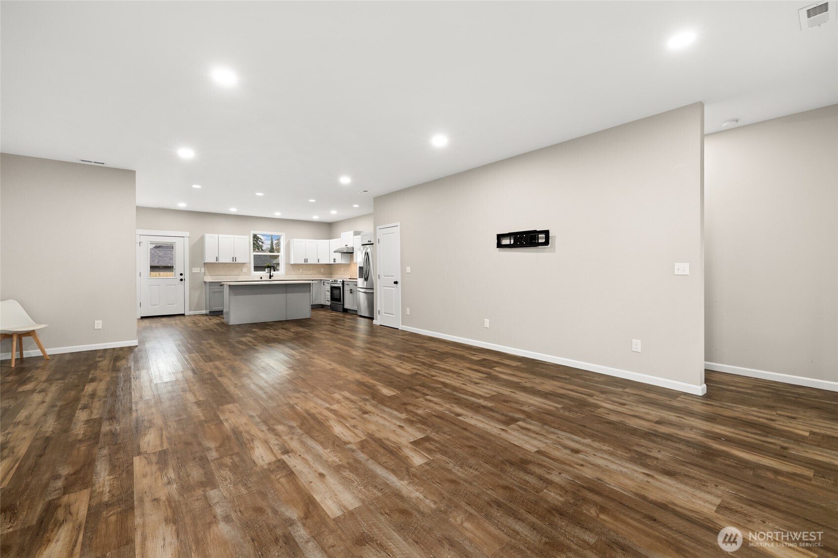 3626 East Howe Street Tacoma, WA 98404 - Photo 4 of 28 a view of kitchen and hall with wooden floor