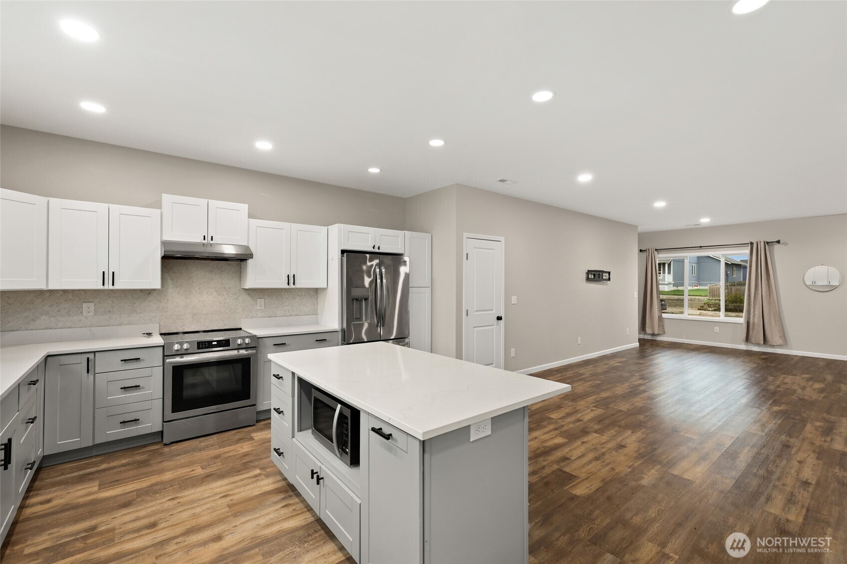 3626 East Howe Street Tacoma, WA 98404 - Photo 9 of 28 a kitchen with stainless steel appliances granite countertop a stove top oven a sink and a refrigerator