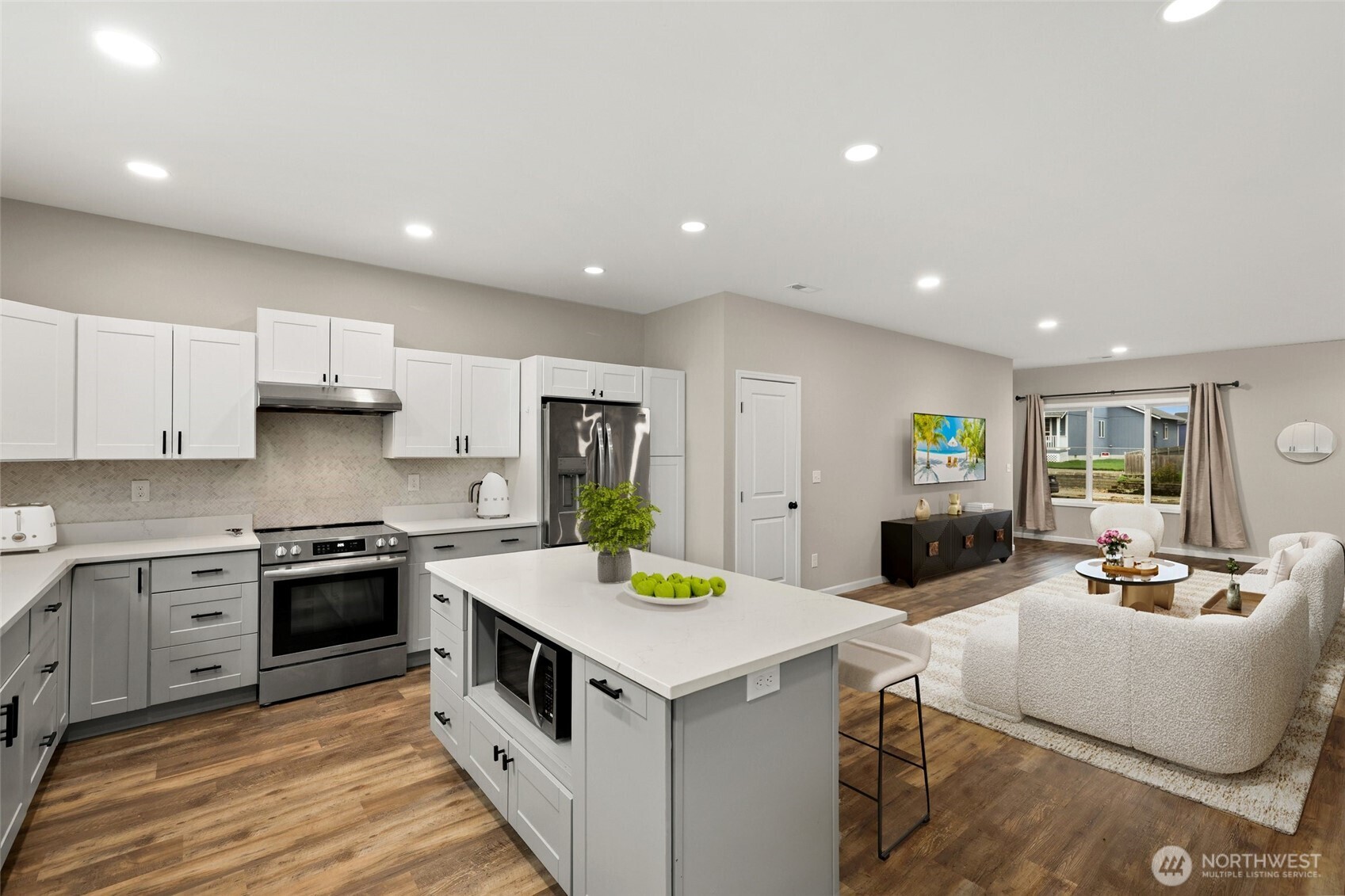 3626 East Howe Street Tacoma, WA 98404 - Photo 10 of 28 a kitchen that has a lot of cabinets in it and wooden floors