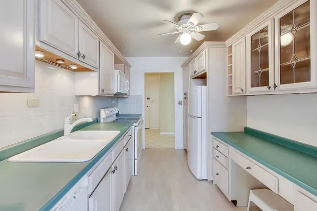 a kitchen with a sink a stove and cabinets