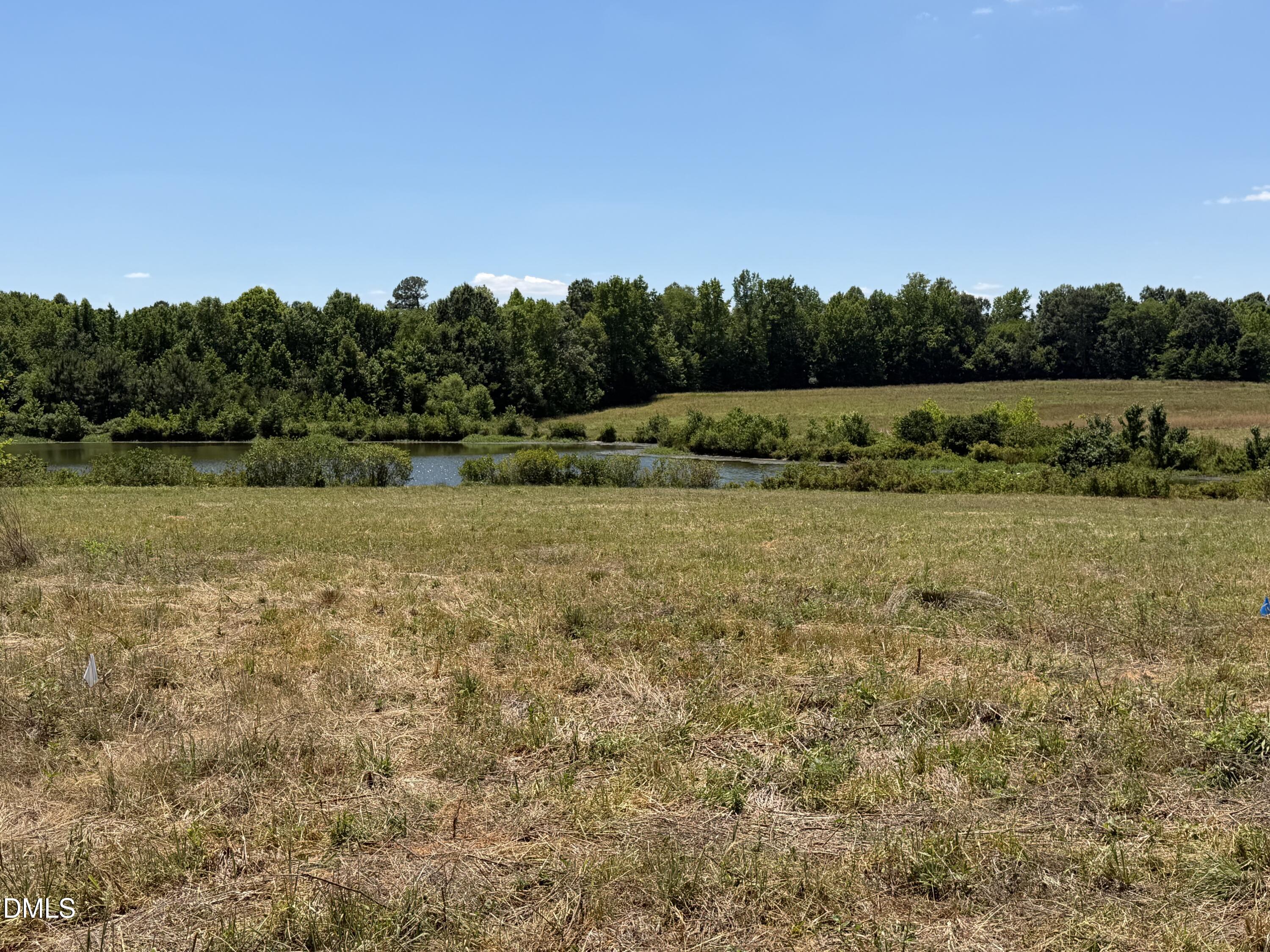 6020 Corbett Ridge Road Mebane, NC 27302 - Photo 19 of 20 a view of a lake with houses in the back
