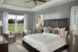 a large bedroom with a bed and large window