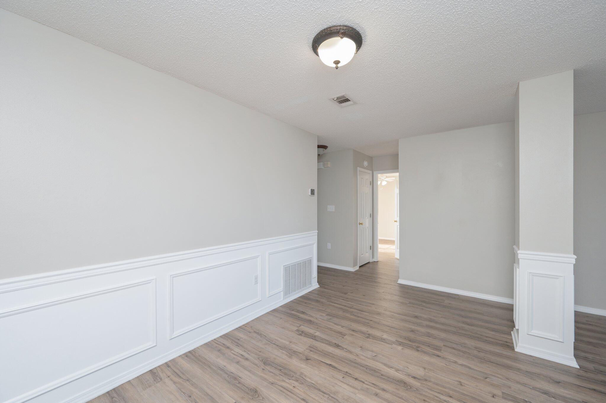 903 Twain Lane Crestview, FL 32536 - Photo 14 of 58 a view of an empty room with wooden floor