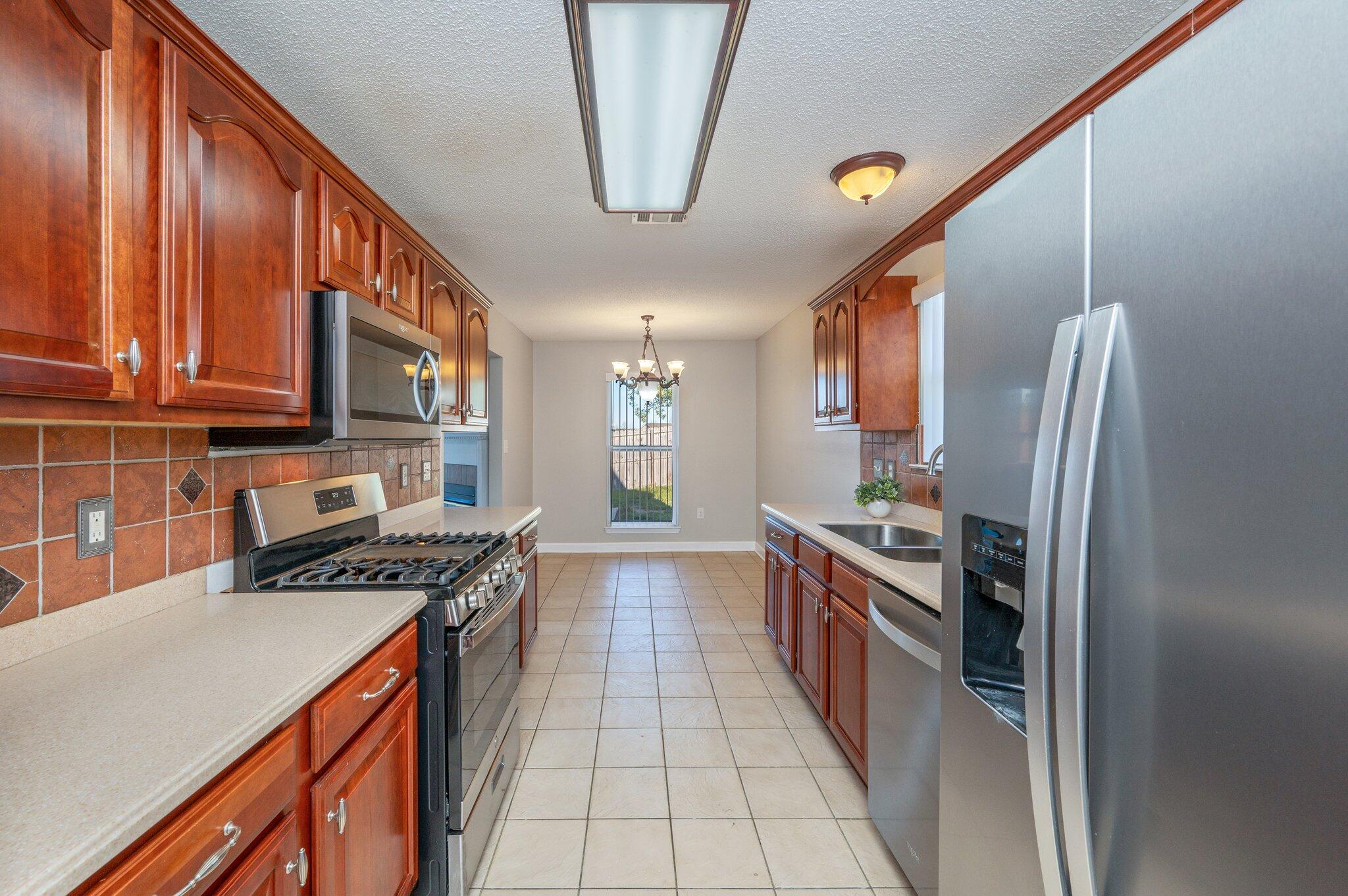 903 Twain Lane Crestview, FL 32536 - Photo 15 of 58 a kitchen with stainless steel appliances granite countertop a stove and a refrigerator