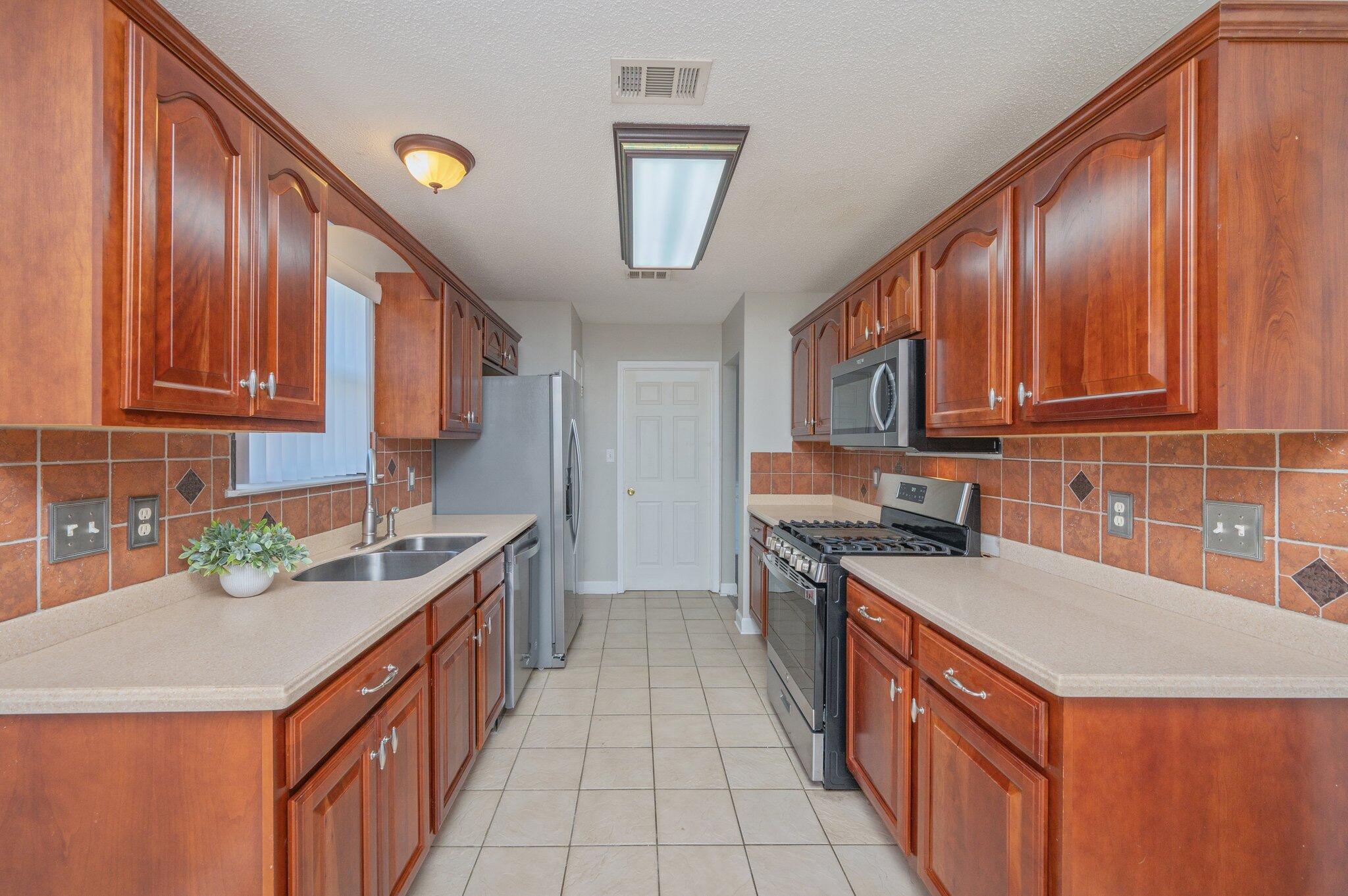 903 Twain Lane Crestview, FL 32536 - Photo 16 of 58 a kitchen with stainless steel appliances granite countertop a sink stove and cabinets