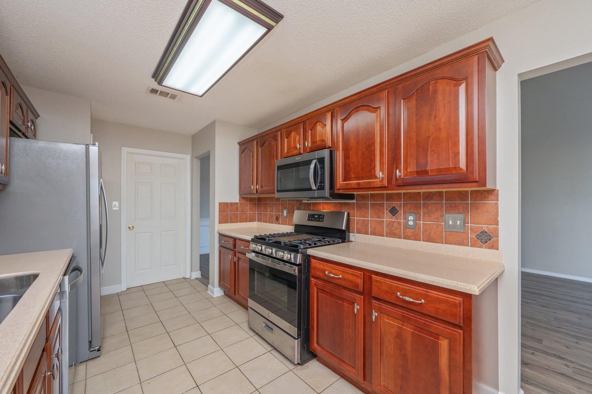 903 Twain Lane Crestview, FL 32536 - Photo 17 of 58 a kitchen with stainless steel appliances granite countertop a refrigerator stove and sink