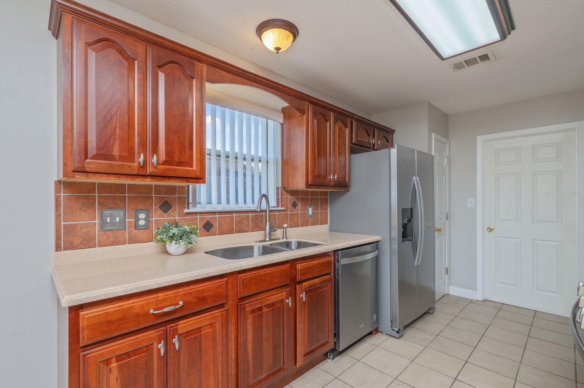 903 Twain Lane Crestview, FL 32536 - Photo 18 of 58 a kitchen with stainless steel appliances granite countertop a sink window and cabinets