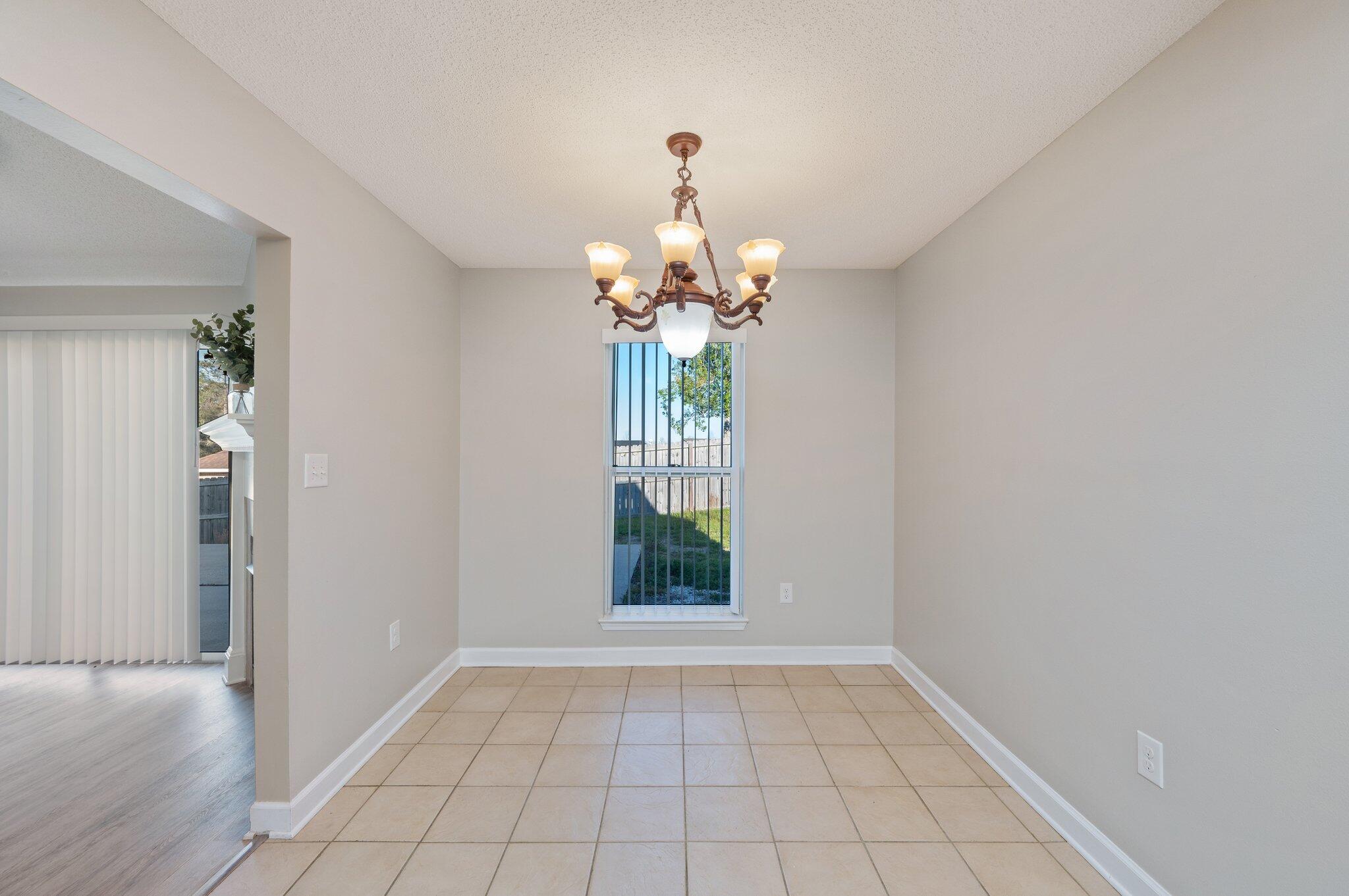 903 Twain Lane Crestview, FL 32536 - Photo 21 of 58 wooden floor in an empty room with a window