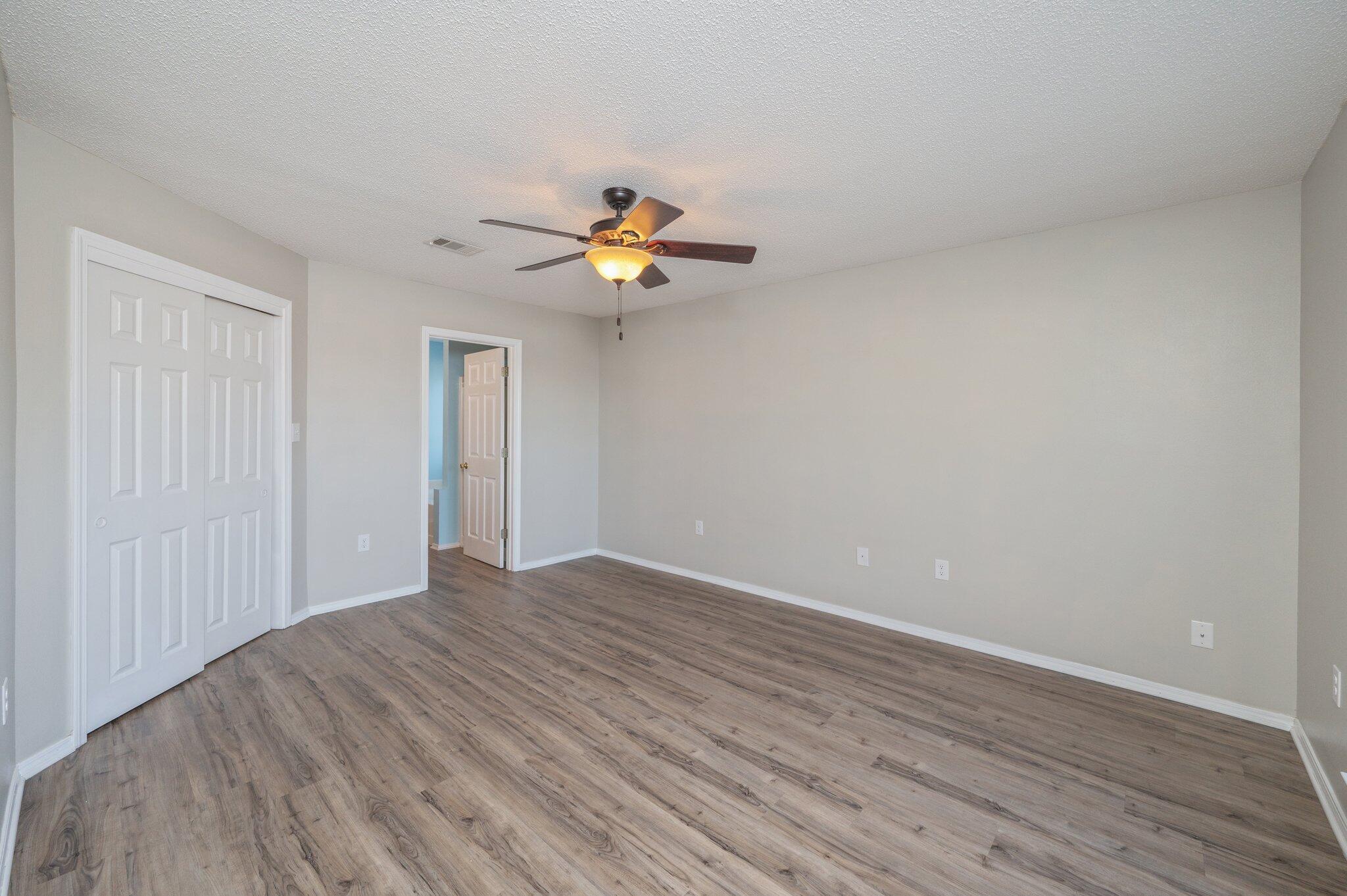 903 Twain Lane Crestview, FL 32536 - Photo 23 of 58 a view of a room with wooden floor and a ceiling fan