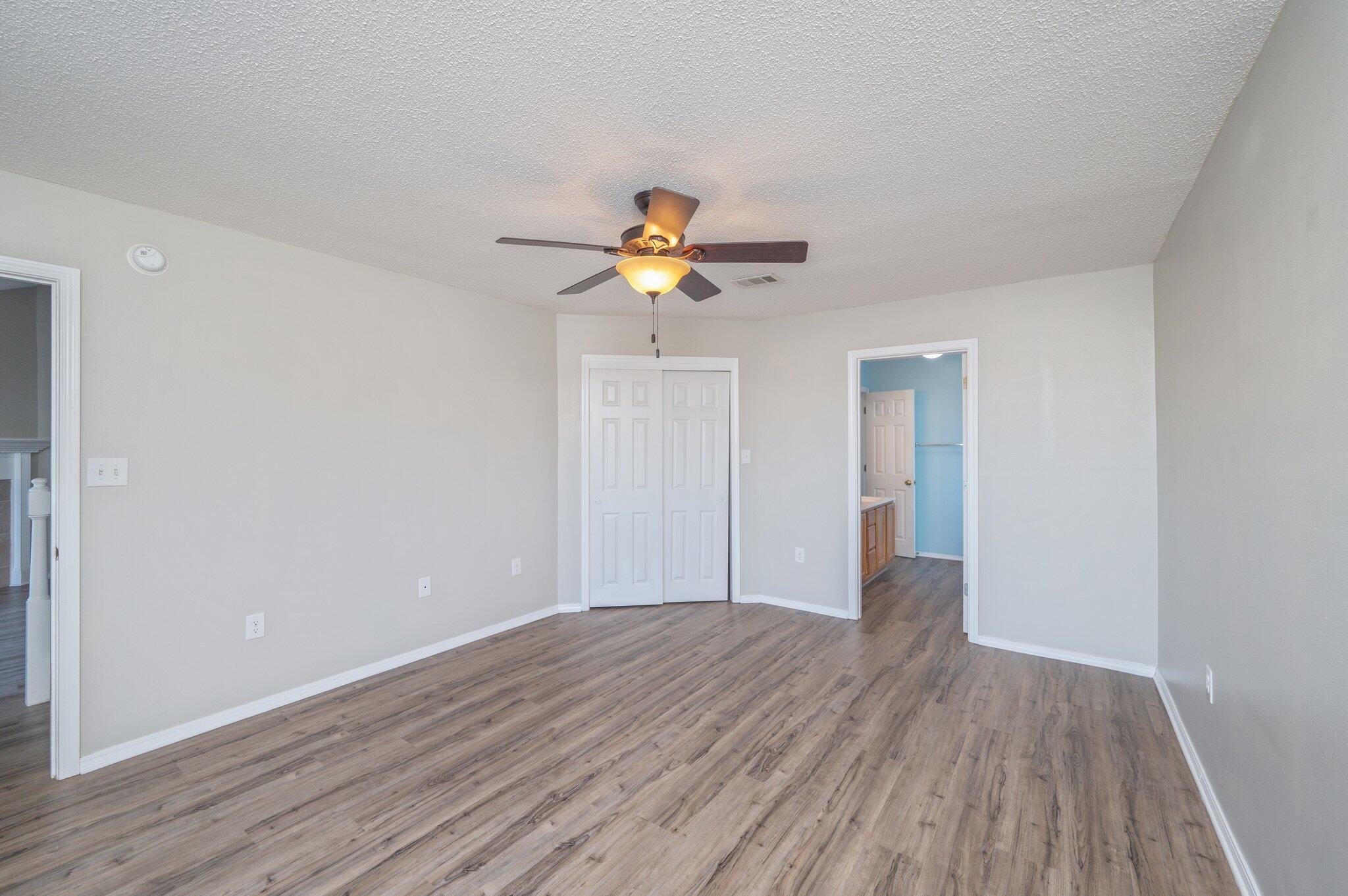 903 Twain Lane Crestview, FL 32536 - Photo 25 of 58 a view of an empty room with wooden floor and a ceiling fan