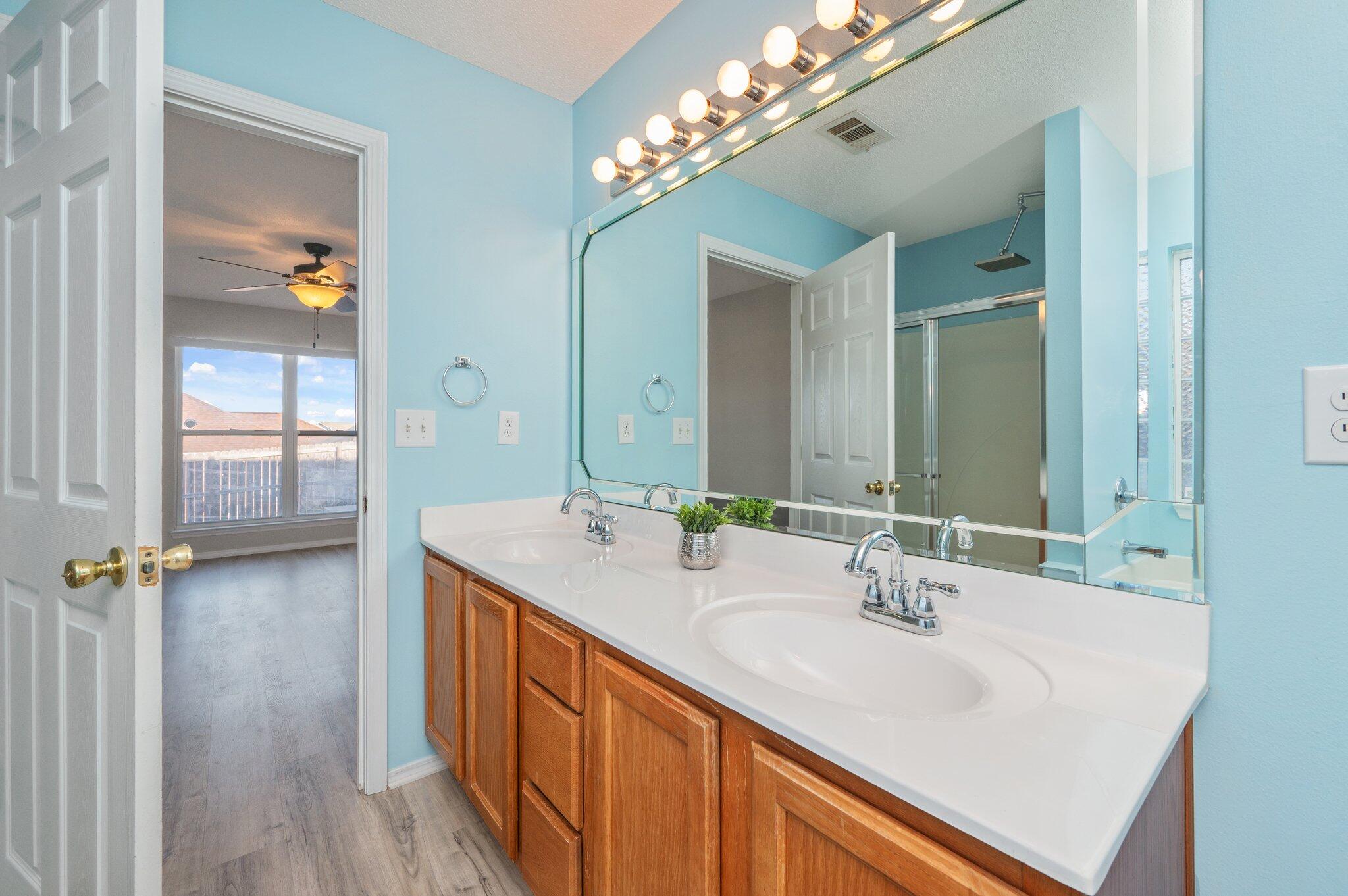 903 Twain Lane Crestview, FL 32536 - Photo 28 of 58 a bathroom with a sink double vanity granite and a mirror