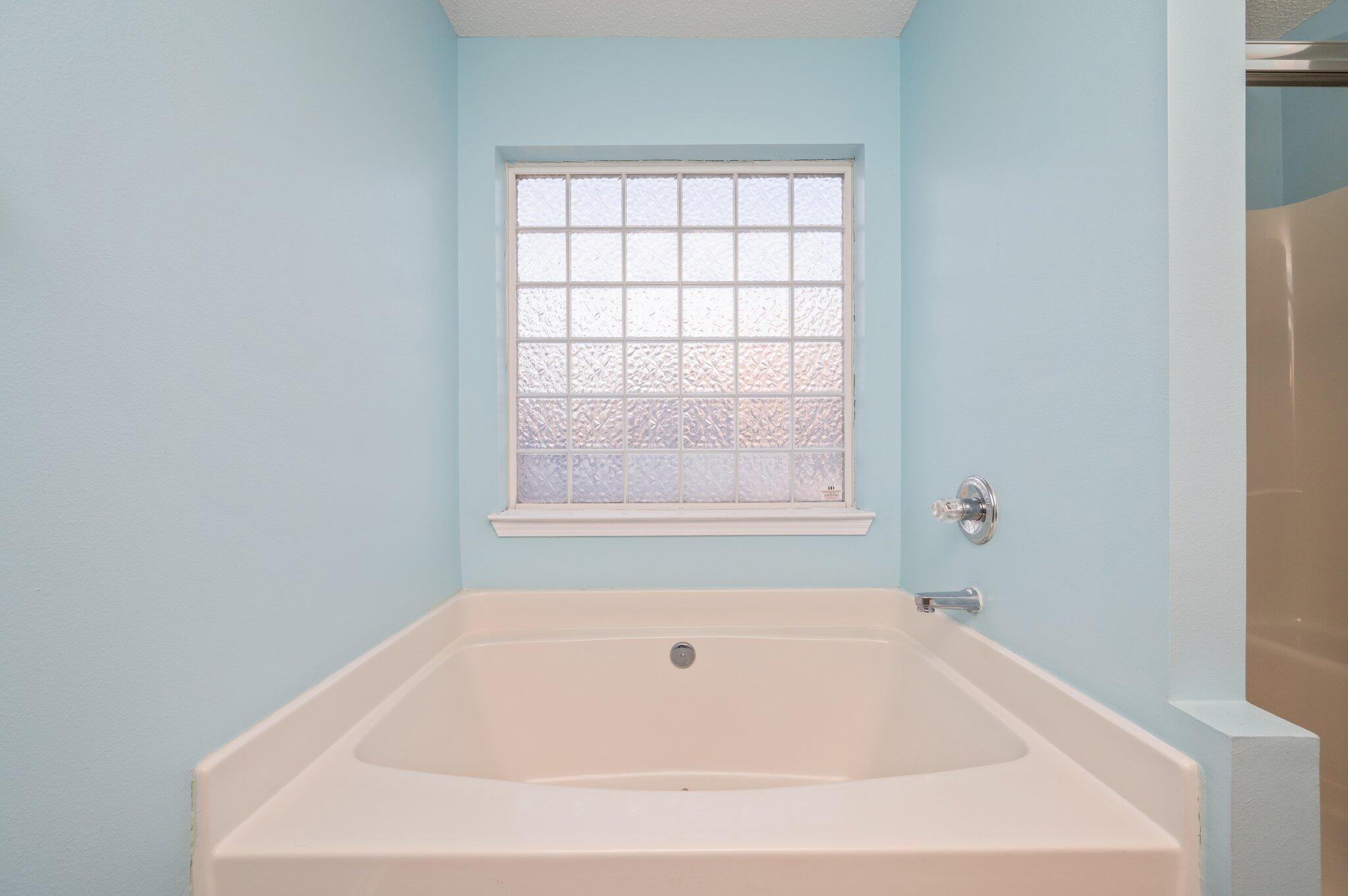 903 Twain Lane Crestview, FL 32536 - Photo 29 of 58 a white bath tub sitting in a bathroom next to a window