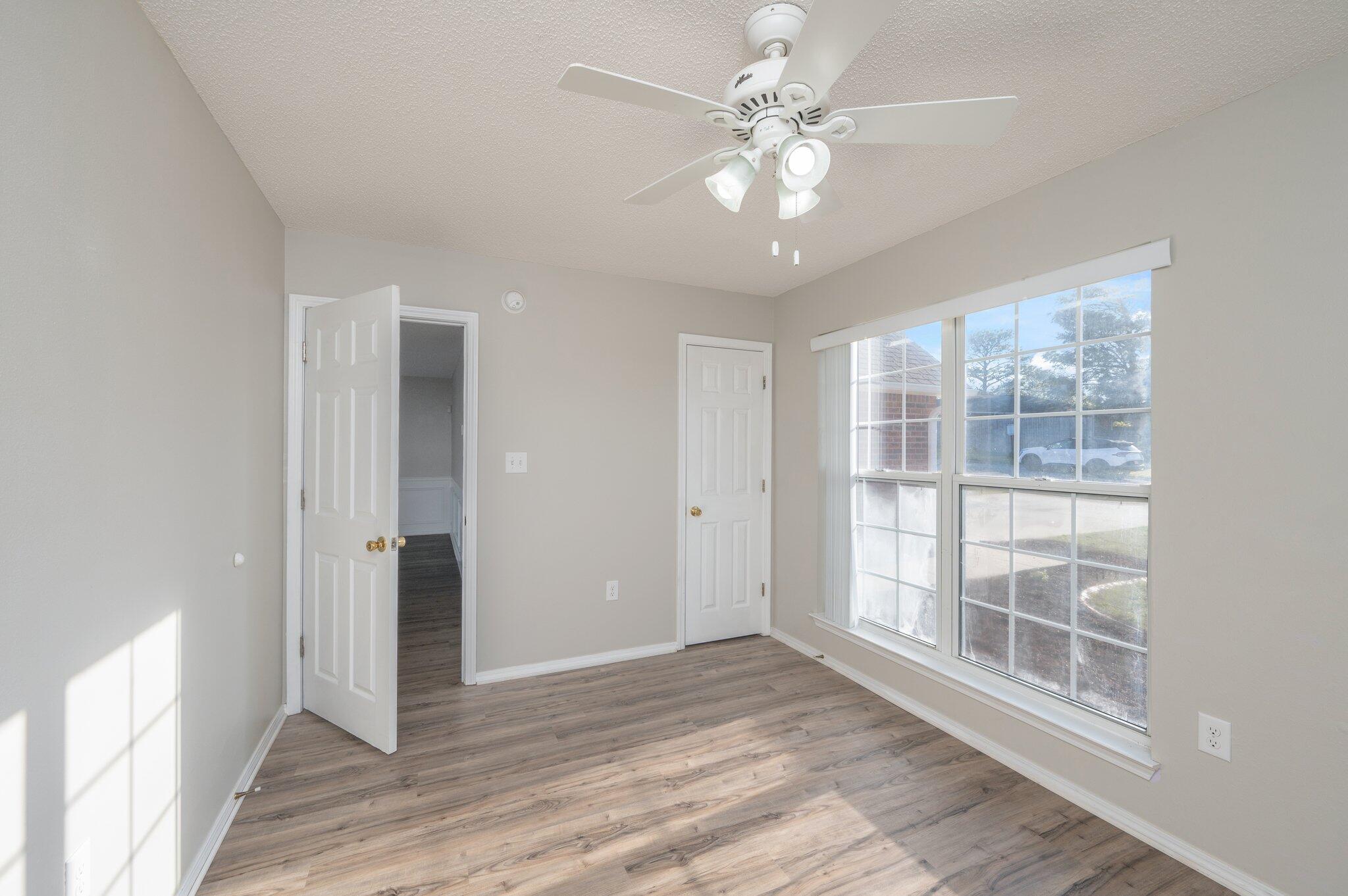 903 Twain Lane Crestview, FL 32536 - Photo 35 of 58 an empty room with wooden floor and windows
