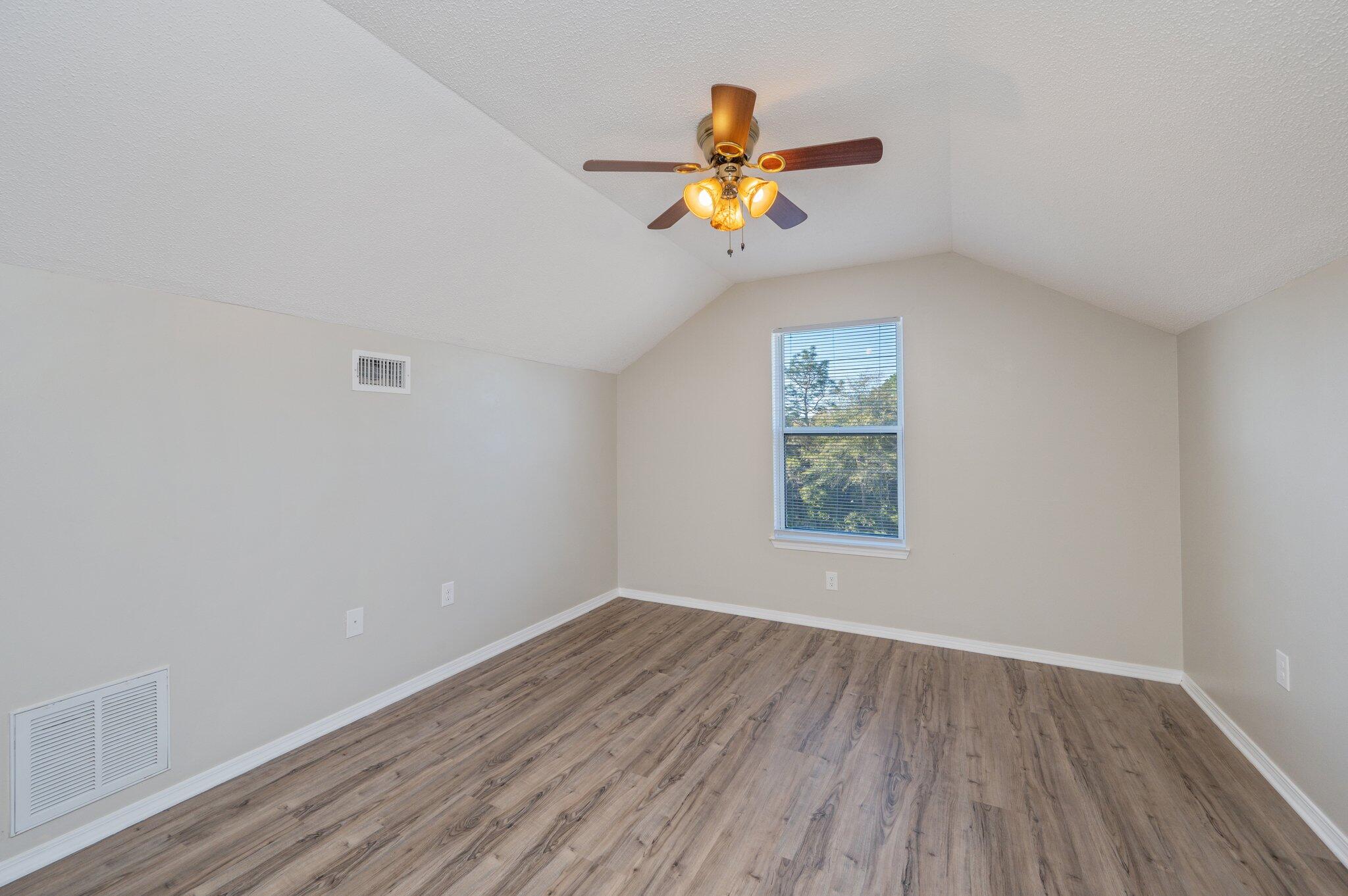 903 Twain Lane Crestview, FL 32536 - Photo 37 of 58 a view of empty room with wooden floor and fan