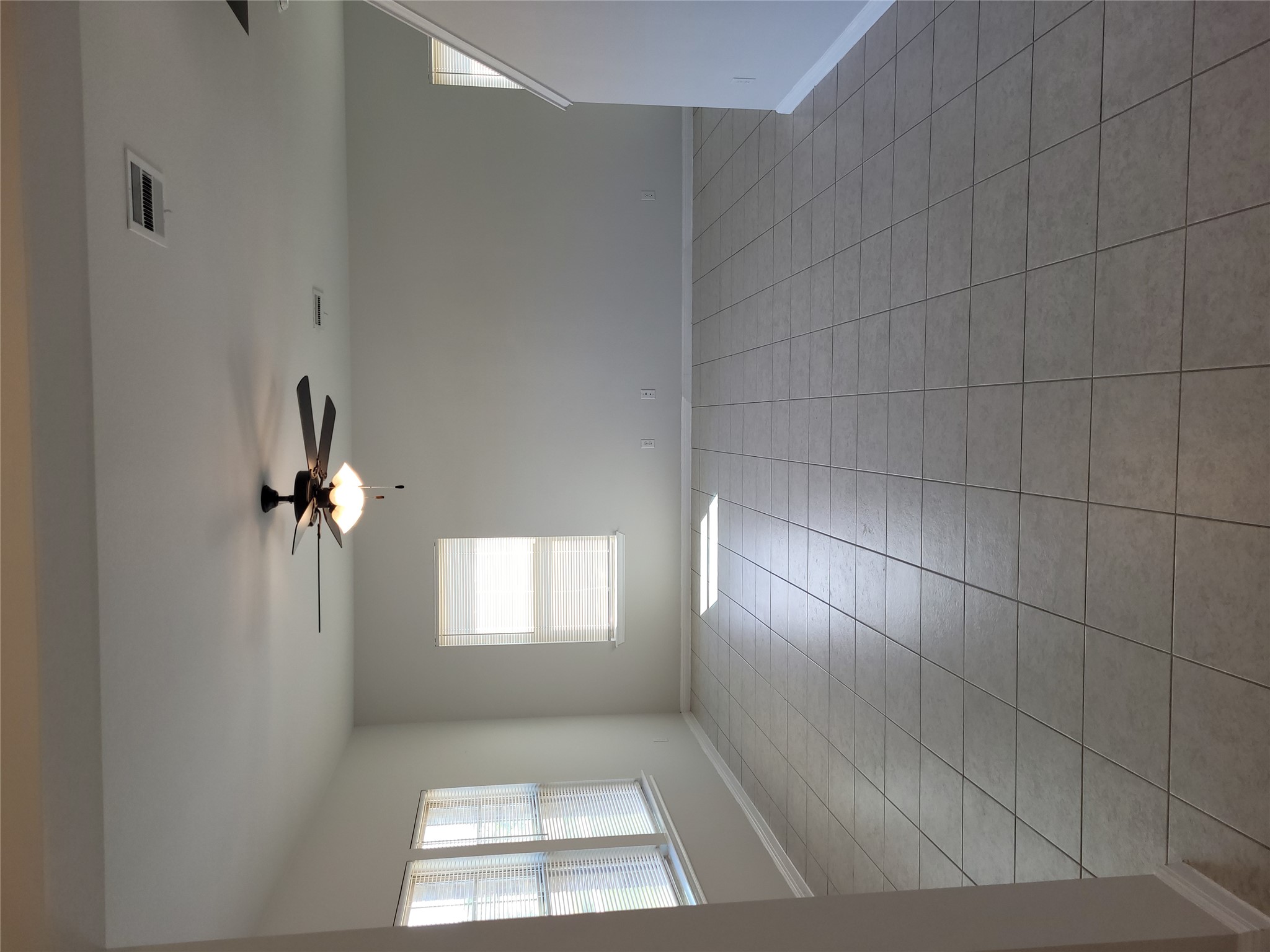 A spacious common area with durable tile flooring and abundant natural light.