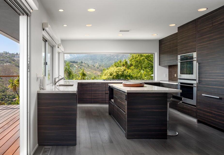 80 Chase Drive Santa Barbara, CA 93108 - Photo 7 of 18 a room with a large window and a table in it