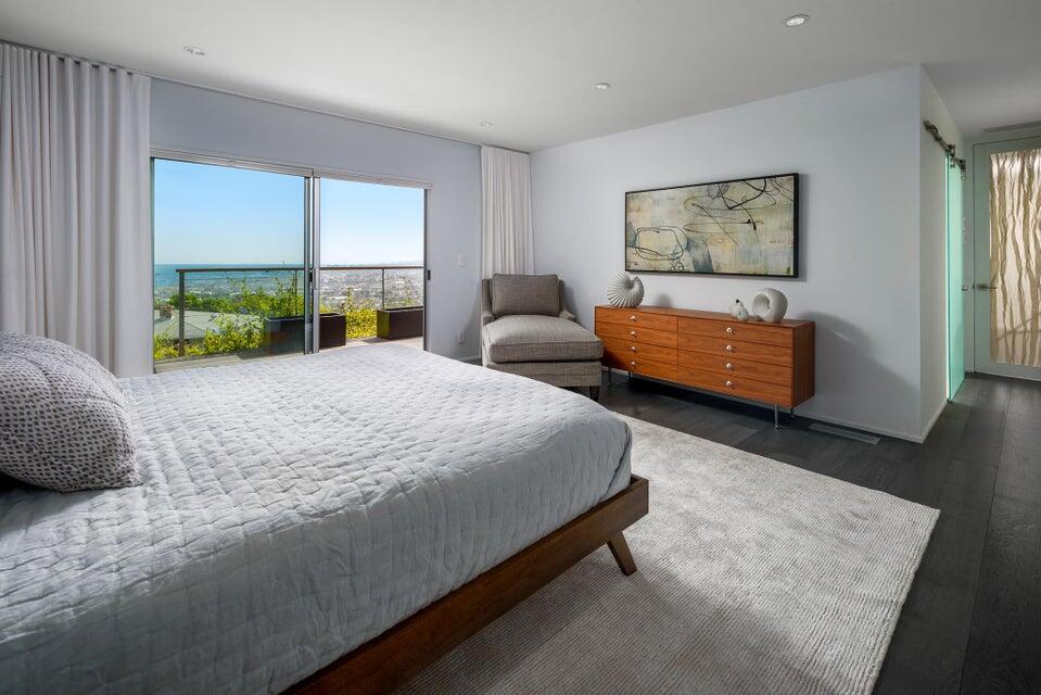 80 Chase Drive Santa Barbara, CA 93108 - Photo 10 of 18 a bedroom with a bed a couch and large window