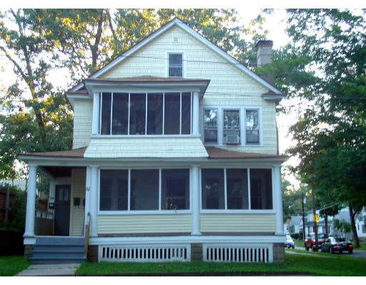 82-84 Lakeside Street Springfield, MA 01109 - Photo 1 of 2 a view of a white house with large windows and a large tree