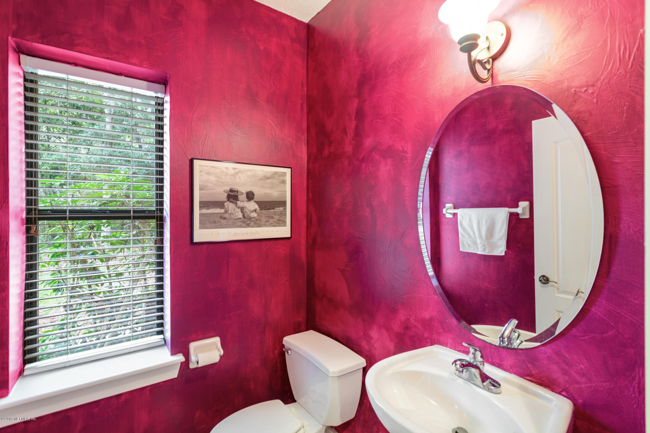 12940 Brady Road Jacksonville, FL 32223 - Photo 18 of 31 a bathroom with a toilet sink and mirror