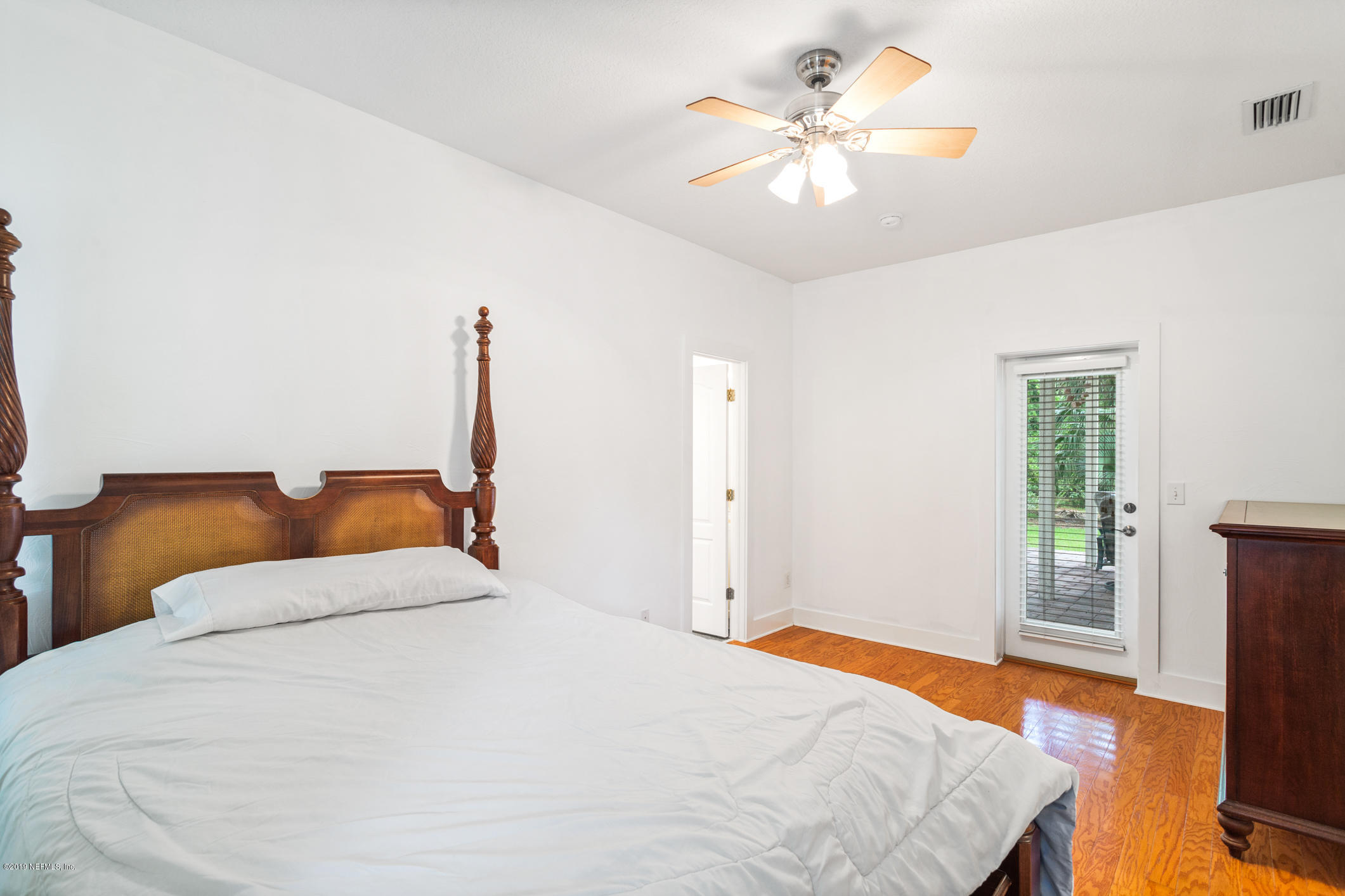 12940 Brady Road Jacksonville, FL 32223 - Photo 19 of 31 a bedroom with a bed and a chandelier