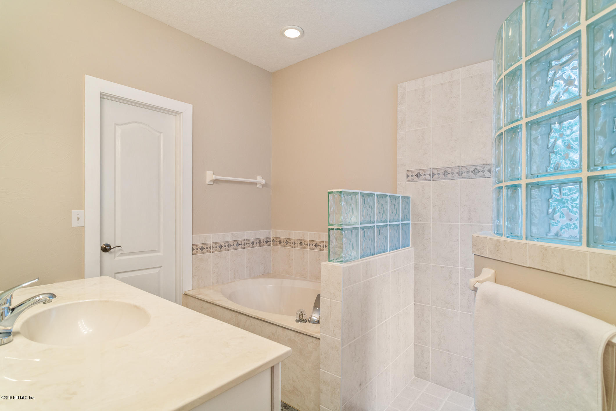 12940 Brady Road Jacksonville, FL 32223 - Photo 21 of 31 a bathroom with a tub sink and vanity