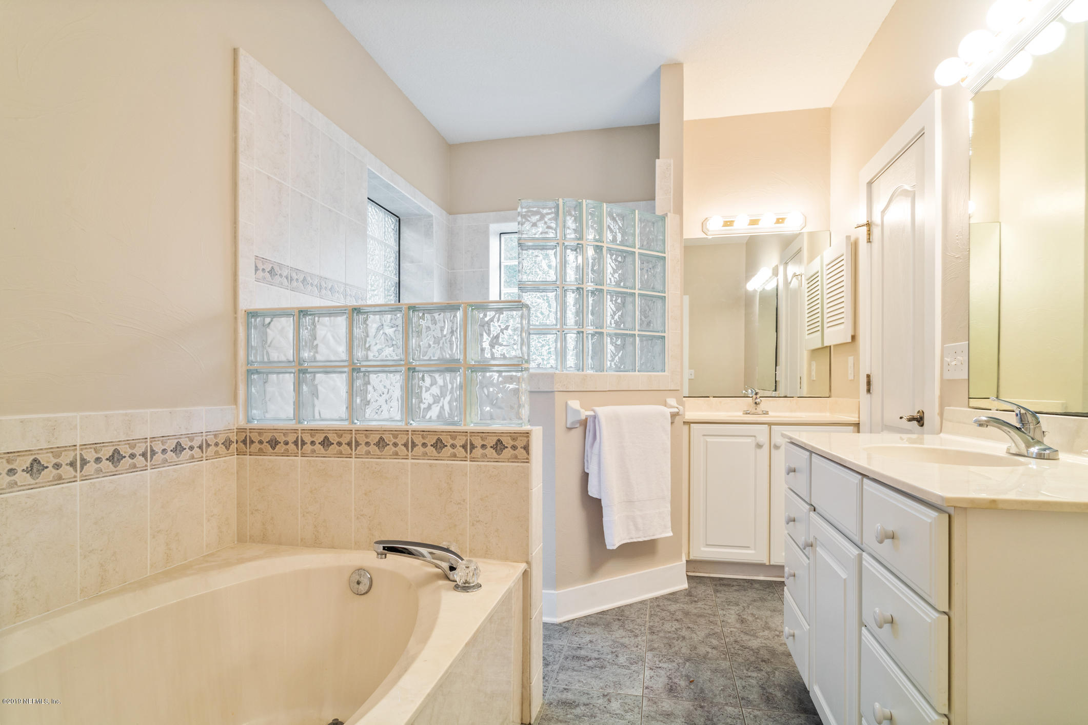 12940 Brady Road Jacksonville, FL 32223 - Photo 23 of 31 a spacious bathroom with a granite countertop sink and a bathtub