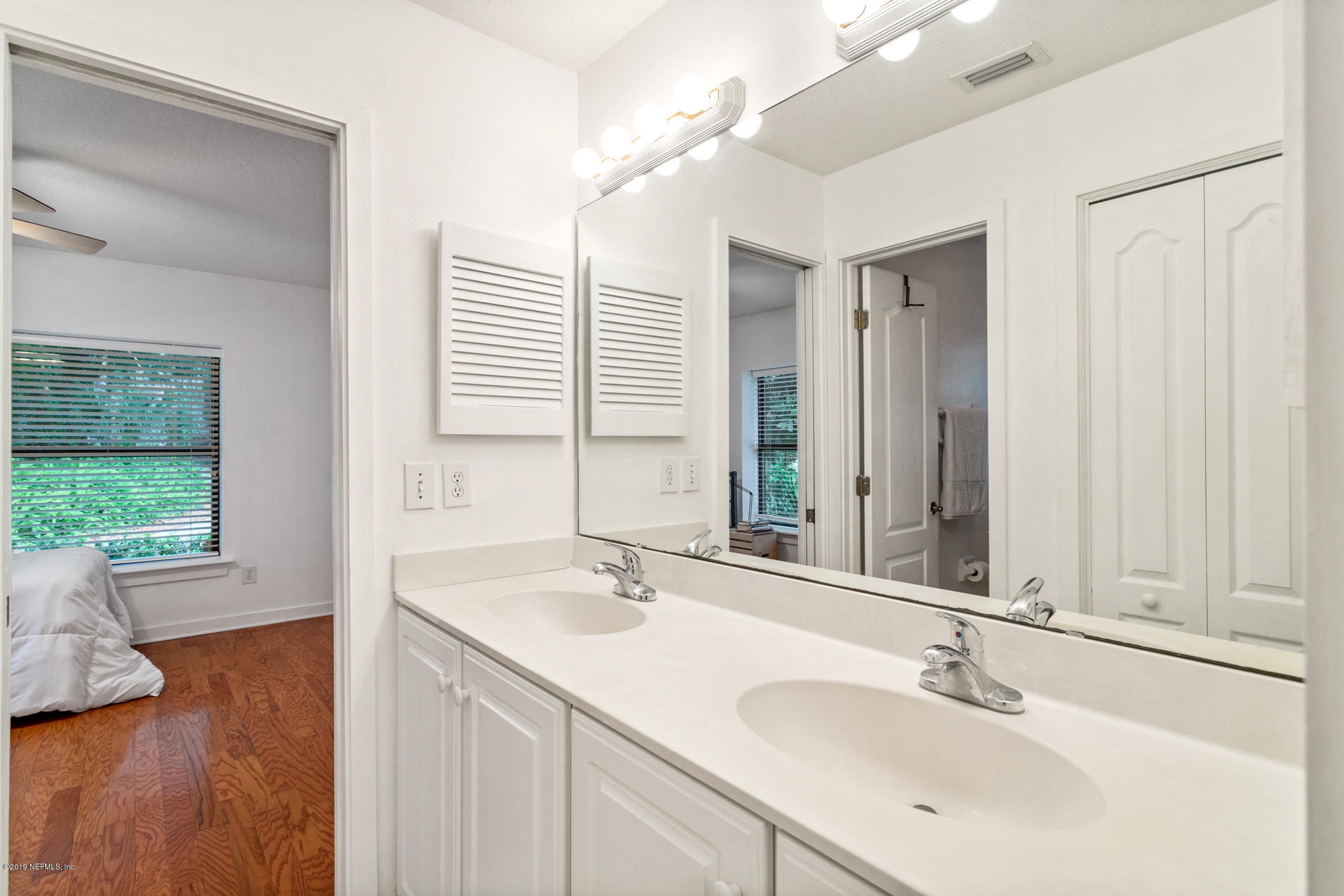 12940 Brady Road Jacksonville, FL 32223 - Photo 24 of 31 a bathroom with a sink and a large mirror