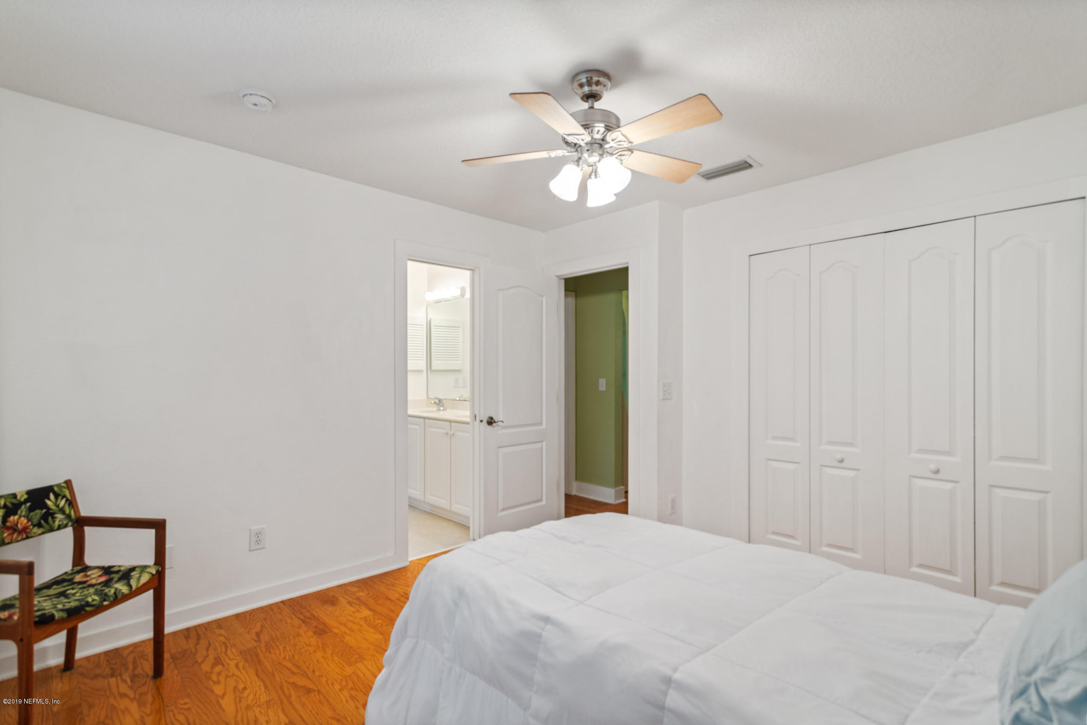 12940 Brady Road Jacksonville, FL 32223 - Photo 25 of 31 a bedroom with a bed and a chandelier
