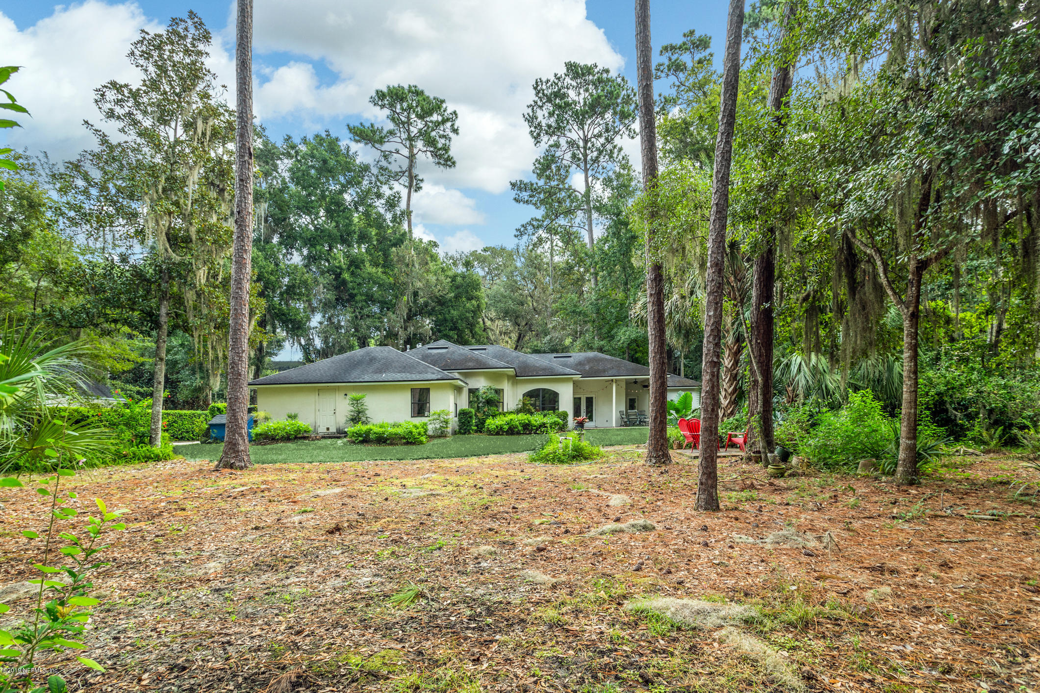 12940 Brady Road Jacksonville, FL 32223 - Photo 31 of 31 a view of house with a big yard and large trees