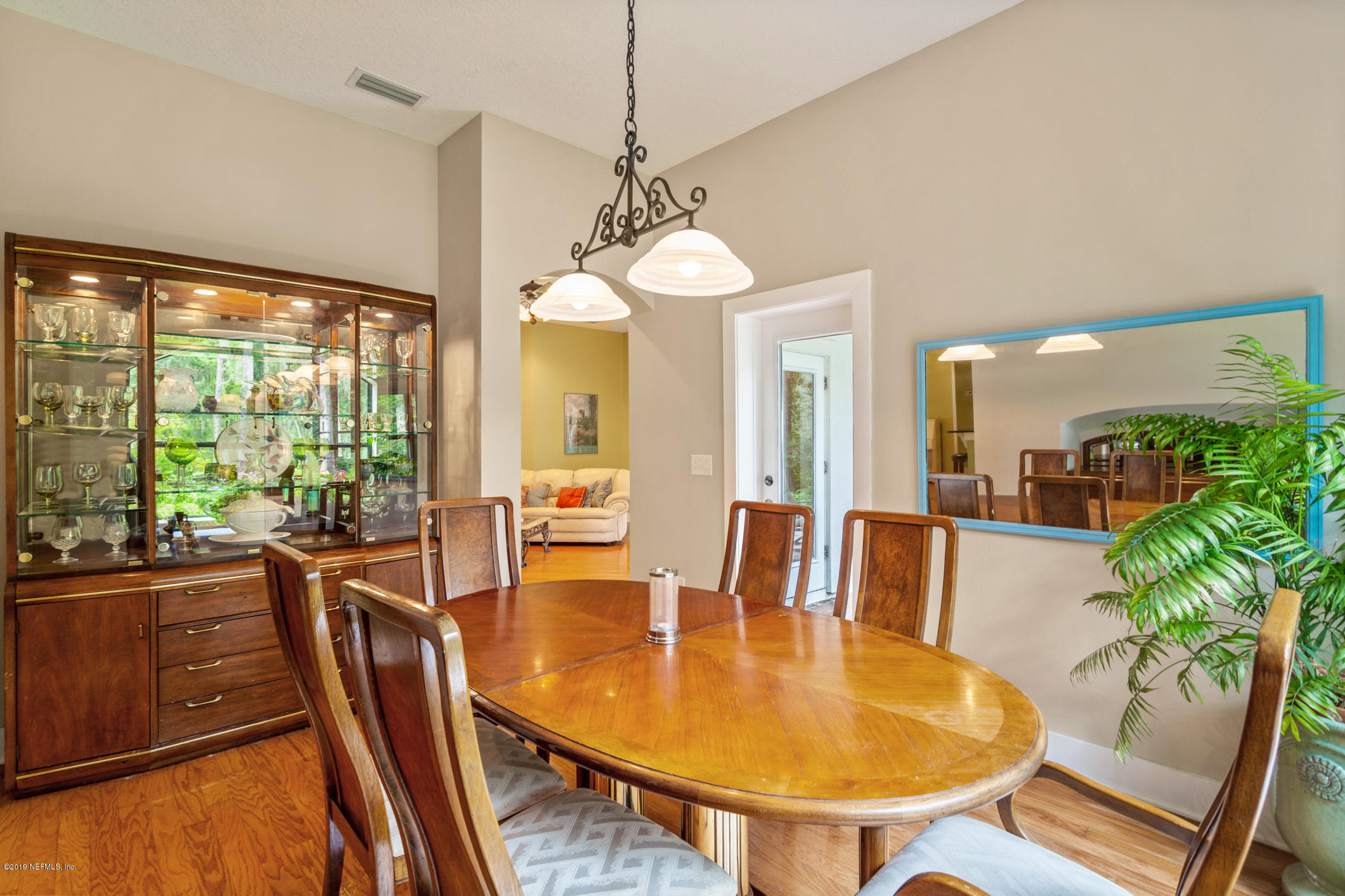 12940 Brady Road Jacksonville, FL 32223 - Photo 4 of 31 a dining room with furniture a chandelier and wooden floor