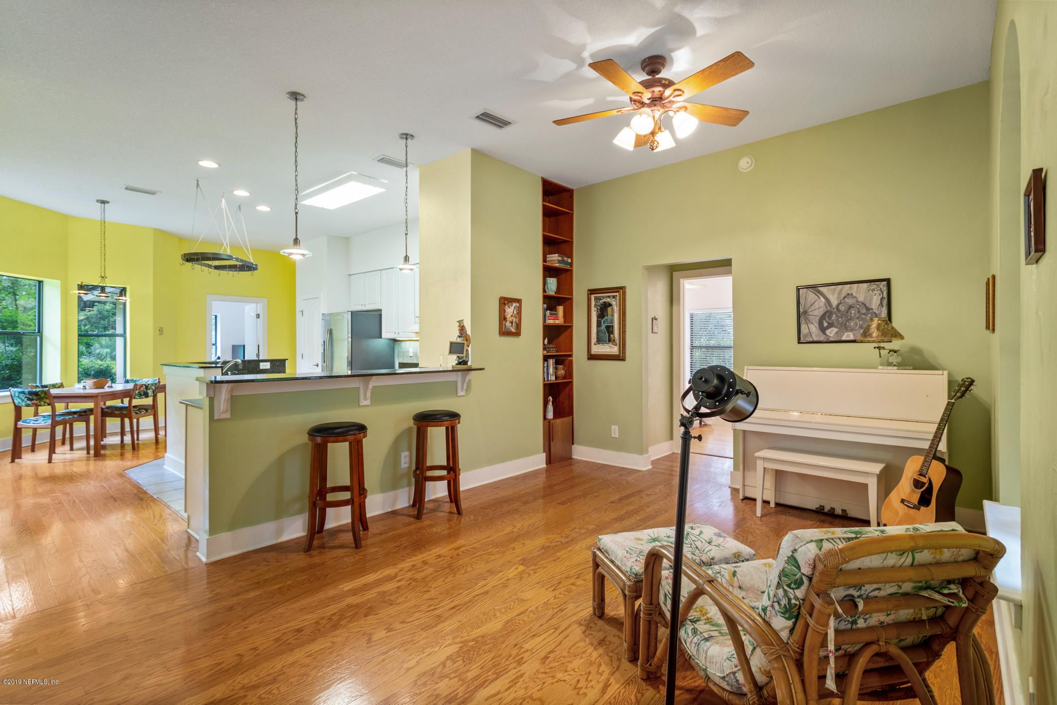 12940 Brady Road Jacksonville, FL 32223 - Photo 7 of 31 a living room with furniture a dining table and a fireplace