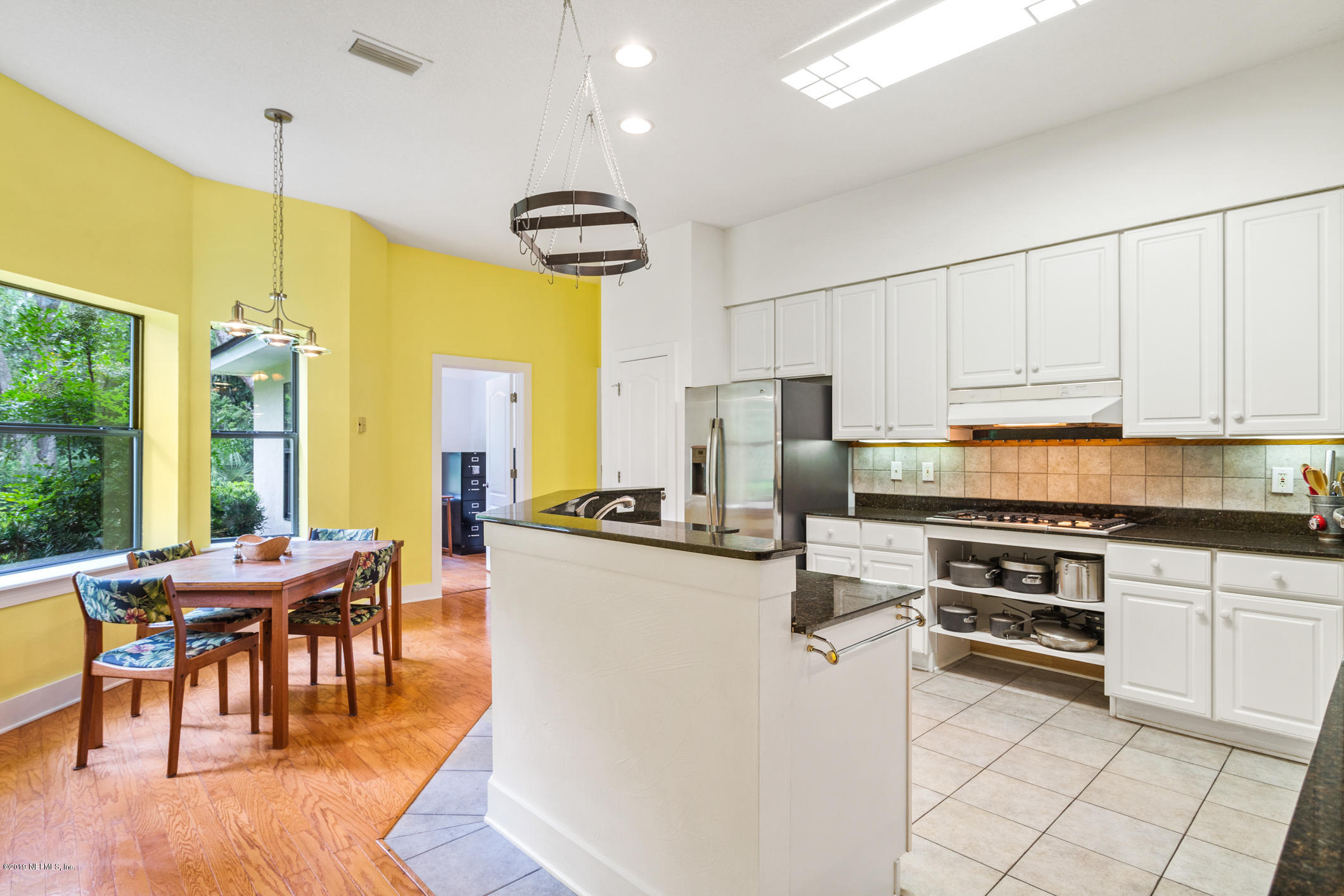 12940 Brady Road Jacksonville, FL 32223 - Photo 8 of 31 a kitchen with stainless steel appliances granite countertop a stove a refrigerator a kitchen island with a dining table and chairs