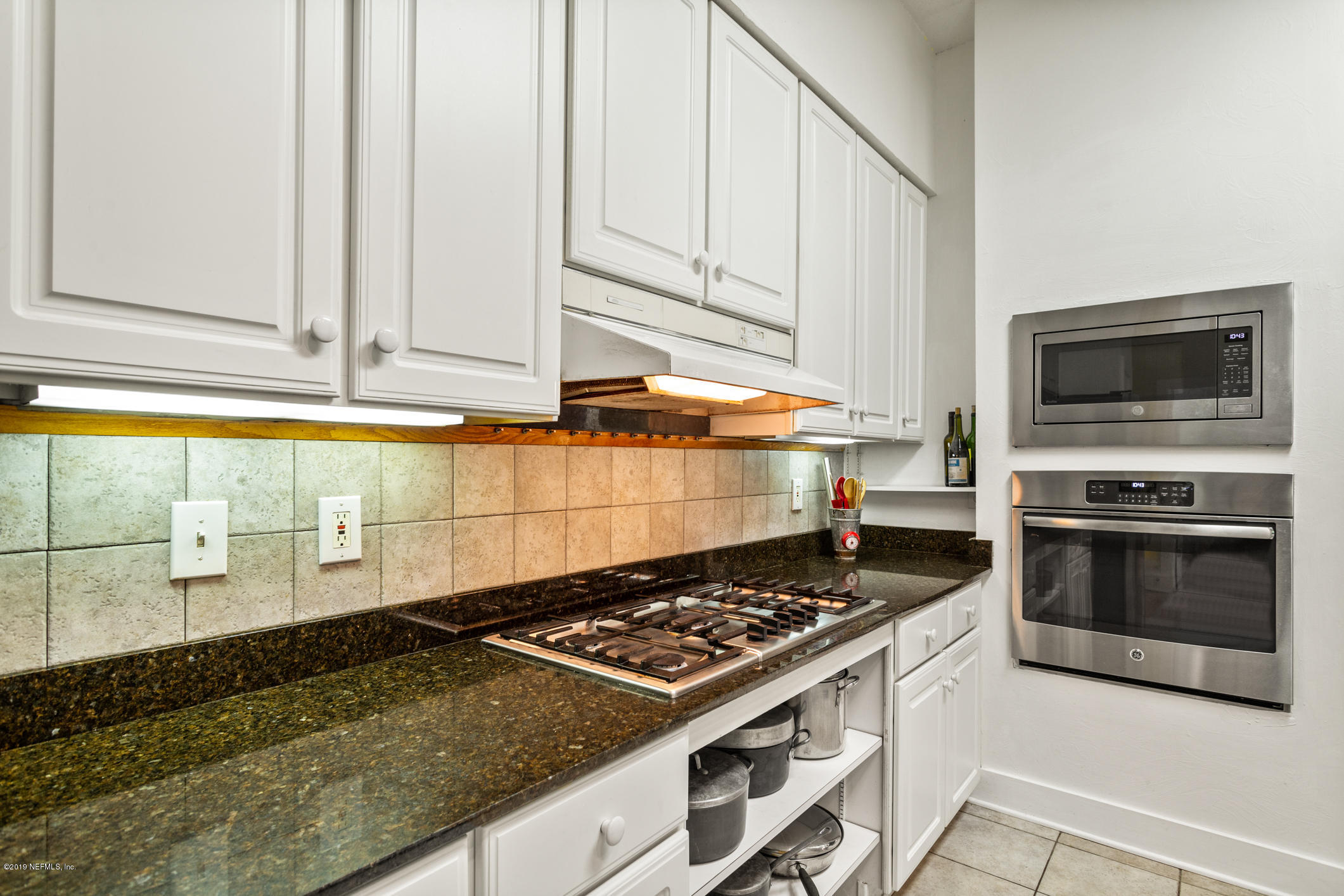 12940 Brady Road Jacksonville, FL 32223 - Photo 9 of 31 a kitchen with a stove a sink and a microwave