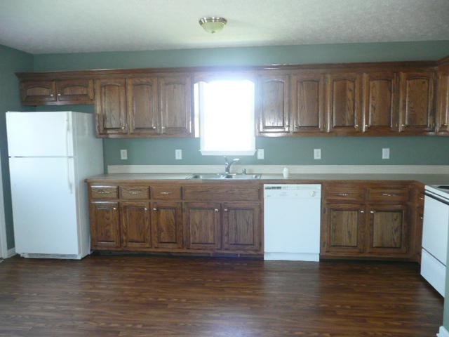 124 Gleaves Lane Oak Grove, KY 42262 - Photo 4 of 14 a kitchen with granite countertop a sink stove and cabinets