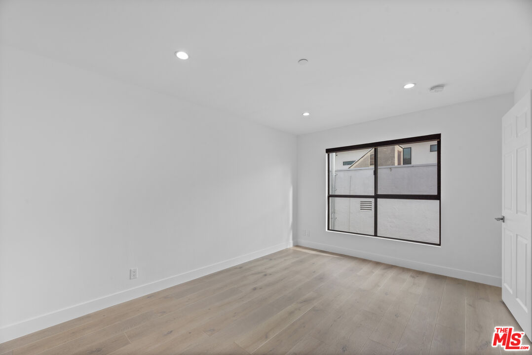 725 North Alfred Street, Unit 202 Los Angeles, CA 90069 - Photo 11 of 28 wooden floor in an empty room with a window