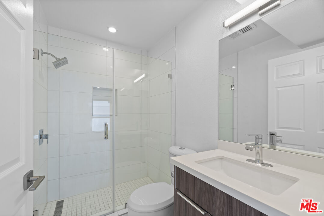 725 North Alfred Street, Unit 202 Los Angeles, CA 90069 - Photo 13 of 28 a bathroom with a sink a toilet and shower