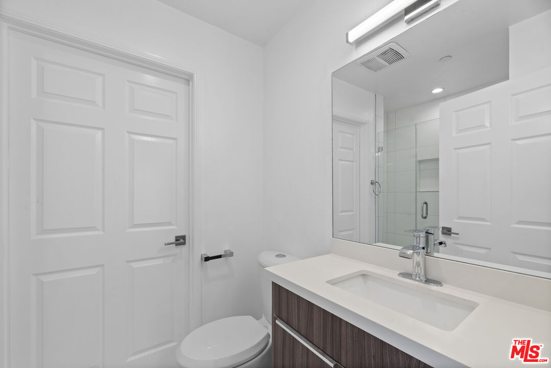 725 North Alfred Street, Unit 202 Los Angeles, CA 90069 - Photo 19 of 28 a bathroom with a sink toilet and vanity