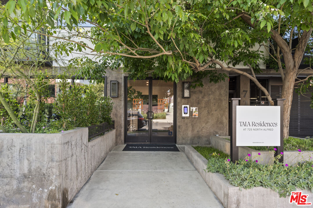 725 North Alfred Street, Unit 202 Los Angeles, CA 90069 - Photo 2 of 28 a front view of a house with a yard