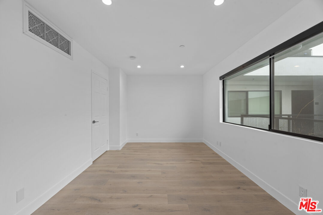 725 North Alfred Street, Unit 202 Los Angeles, CA 90069 - Photo 21 of 28 a view of an empty room with a window
