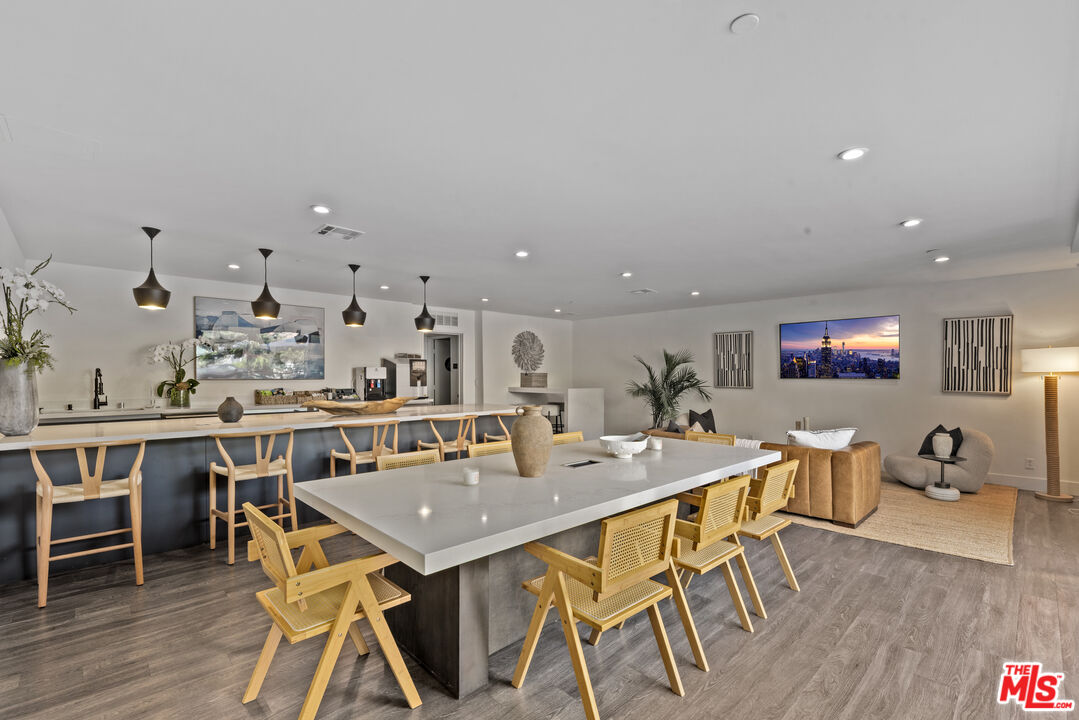 725 North Alfred Street, Unit 202 Los Angeles, CA 90069 - Photo 25 of 28 a view of a dining room with furniture and wooden floor