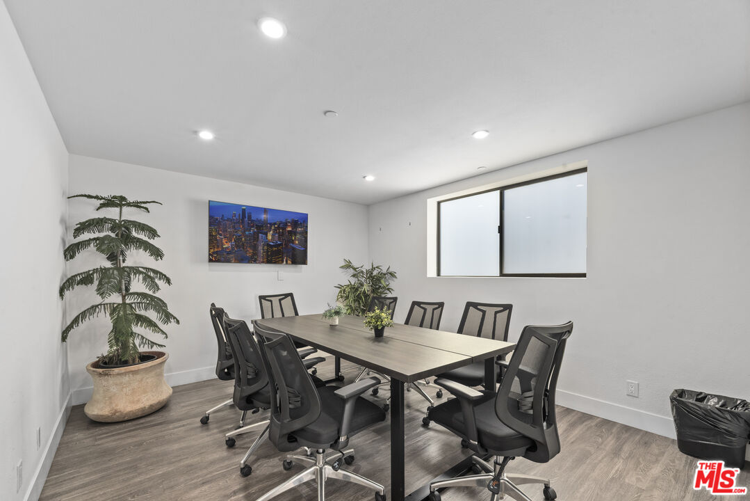 725 North Alfred Street, Unit 202 Los Angeles, CA 90069 - Photo 27 of 28 a view of a dining room with furniture and wooden floor