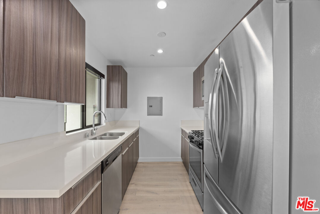 725 North Alfred Street, Unit 202 Los Angeles, CA 90069 - Photo 7 of 28 a kitchen with stainless steel appliances granite countertop a refrigerator and a stove