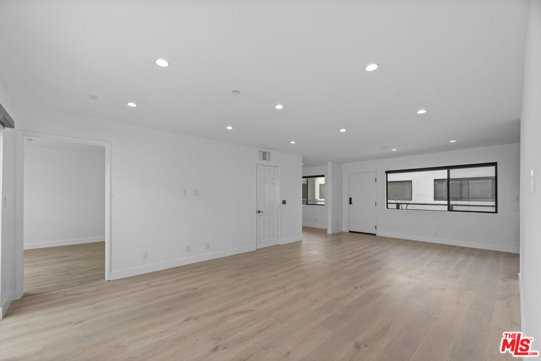 725 North Alfred Street, Unit 202 Los Angeles, CA 90069 - Photo 10 of 28 an empty room with wooden floor and windows