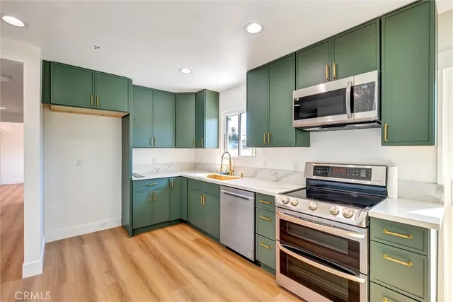 a kitchen with stainless steel appliances a stove and microwave