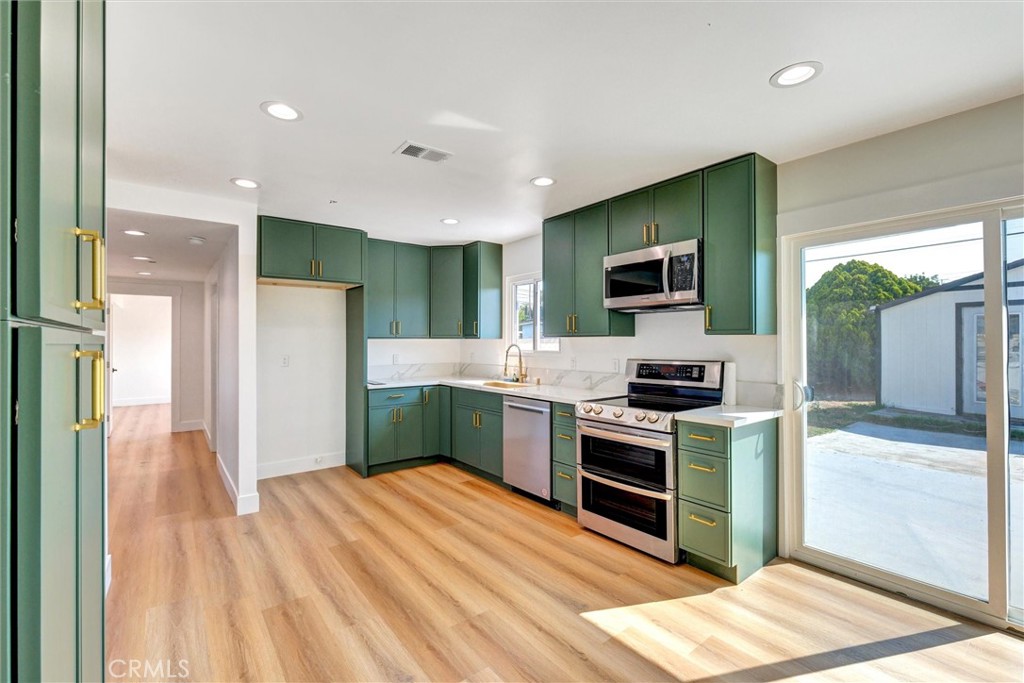 18106 Coltman Avenue Carson, CA 90746 - Photo 6 of 12 a kitchen with stainless steel appliances kitchen island granite countertop a refrigerator and a stove top oven
