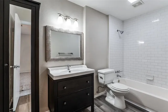 a bathroom with a toilet a sink and bathtub